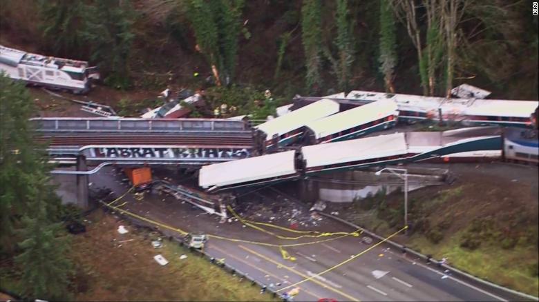 Aerial images show the deadly Amtrak derailment with the train sprawled across the track and highway on Monday.